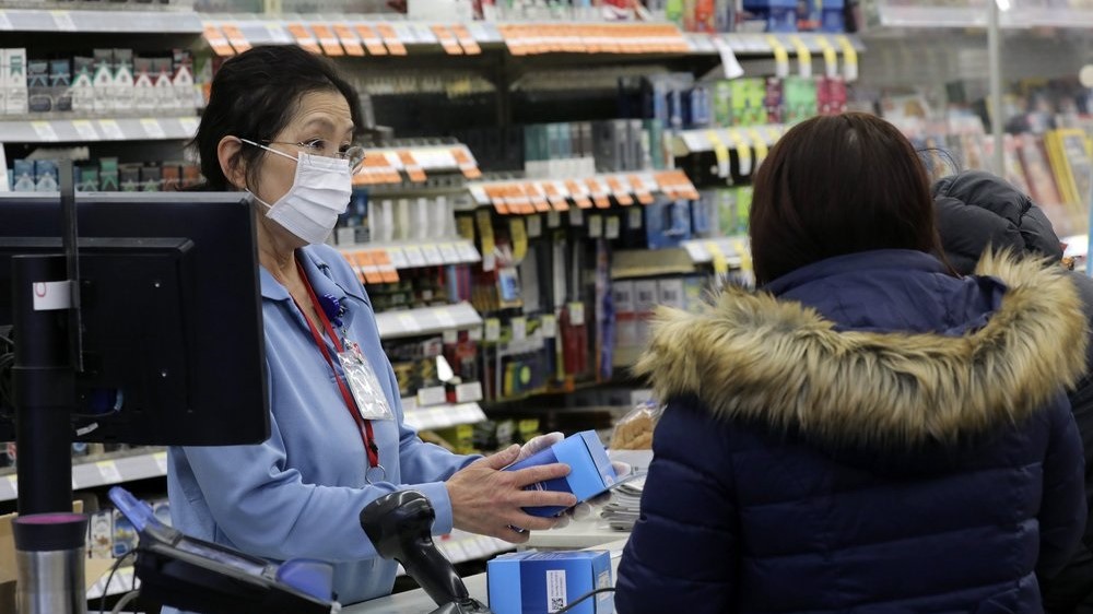A sales clerk at a pharmacy rings up a purchase of face masks as fears of the coronavirus continues, Friday, Jan 24, 2020 in Chicago.