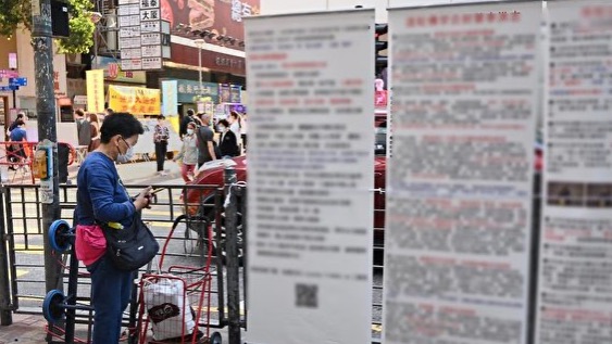 在旺角到處放置誣衊法輪功展示架的老婦，被發現後自曝聽命於深圳共產黨。