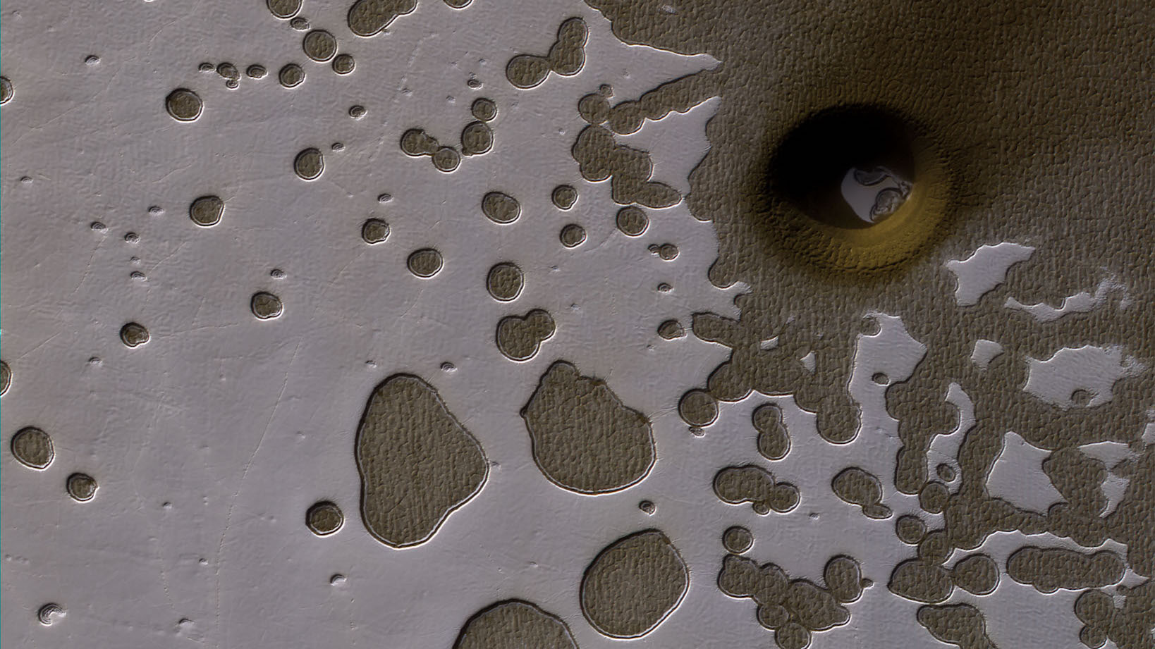 Mysterious Circular Depression Discovered in Mars’ ‘Swiss Cheese Terrain’